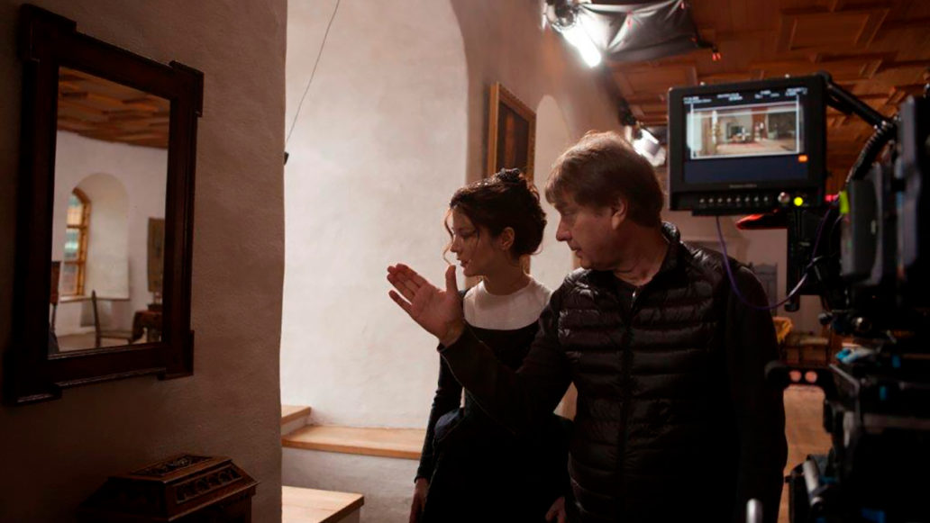 A director guiding an actress in 19th century manor setting. 