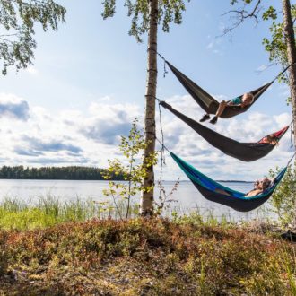 Three hammocks between two trees one on top of each other