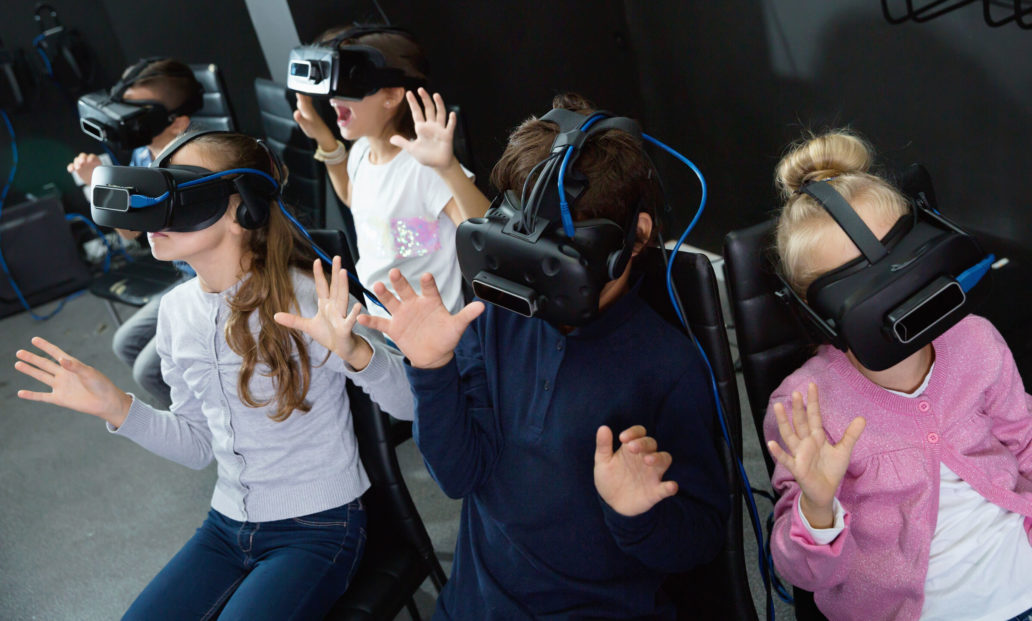 Children wearing virtual reality glasses.