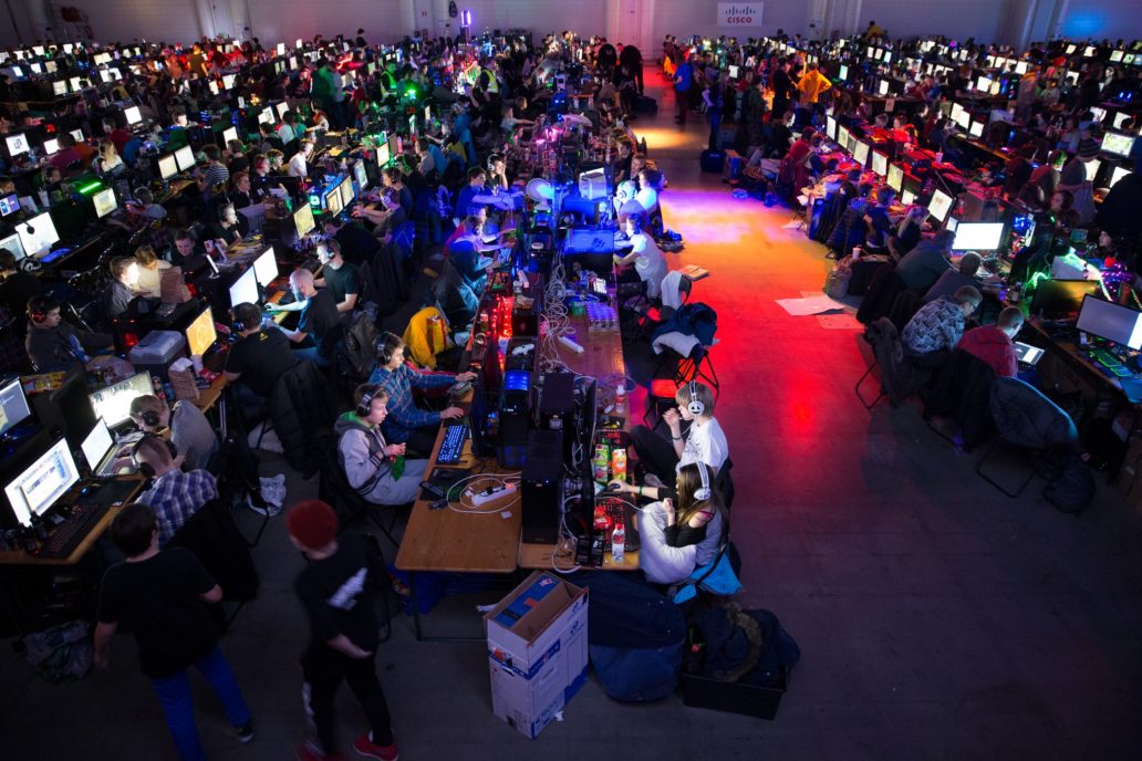 People at an event playing video games.