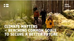 Three people walking in a forest with coats on and text Climate Matters