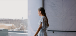 A young woman looking out of the window.